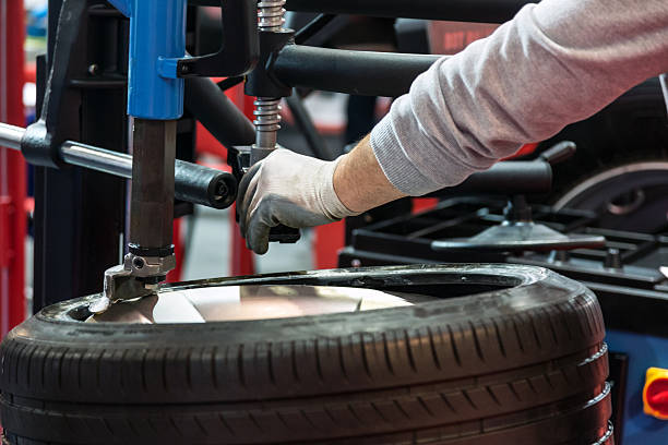 Auto mechanic changing tire