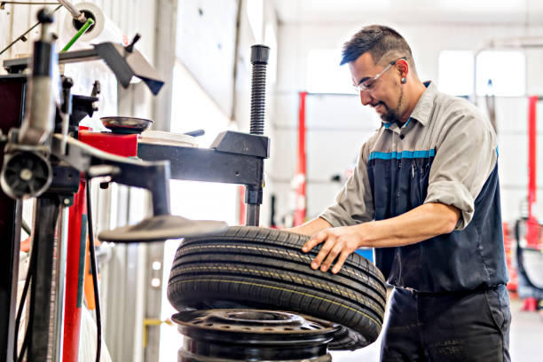 Mechanic changing car tire at work