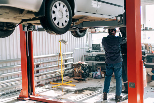 Professional mechanic repairs an internal combustion engine and changes the oil.