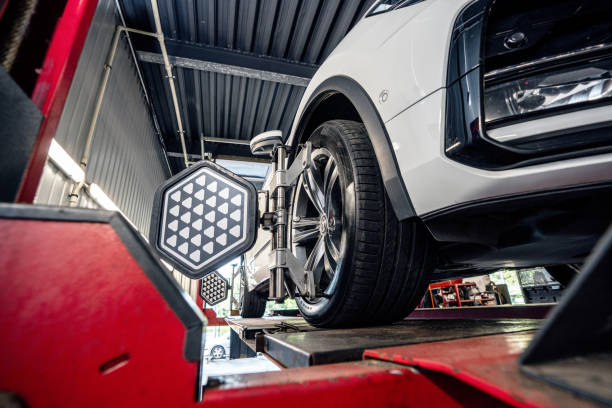 Professional wheel alignment process with precision tools in an automotive service center for safety, performance, and maintenance concepts